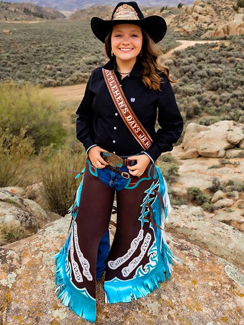 Jr Miss Dixie Sponable at Hartman Rocks in black hat with crown, black top, and custom brown and turquoise chaps.